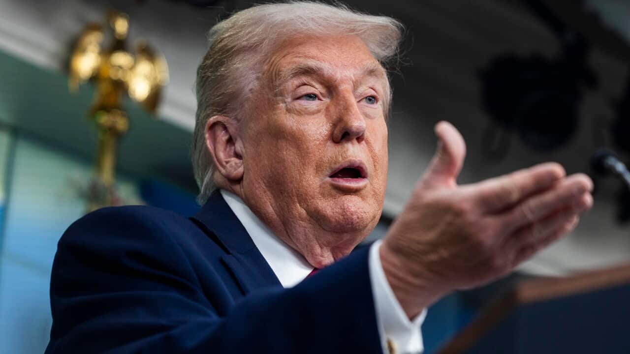 US President Trump speaks on to reporters ahead of trip to Davos