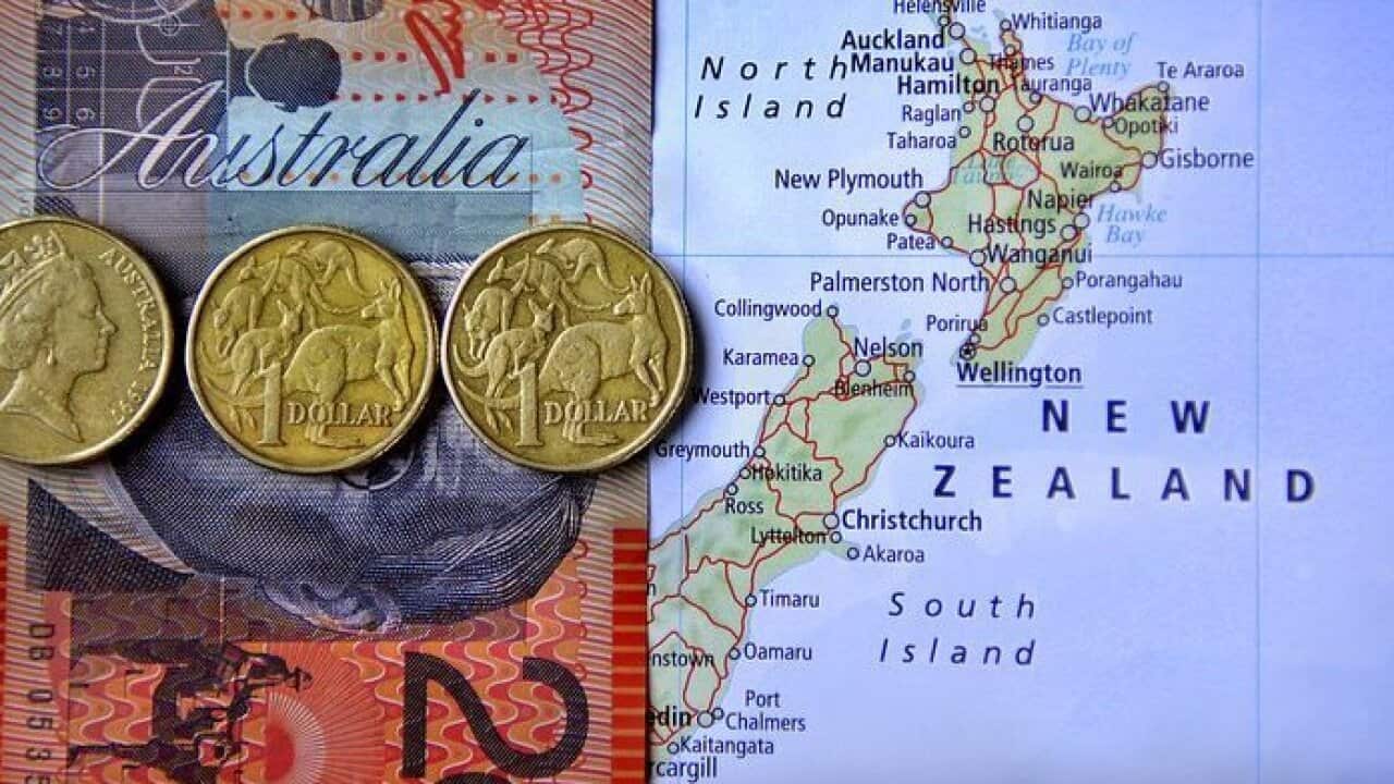 Australian money is seen against a map of New Zealand