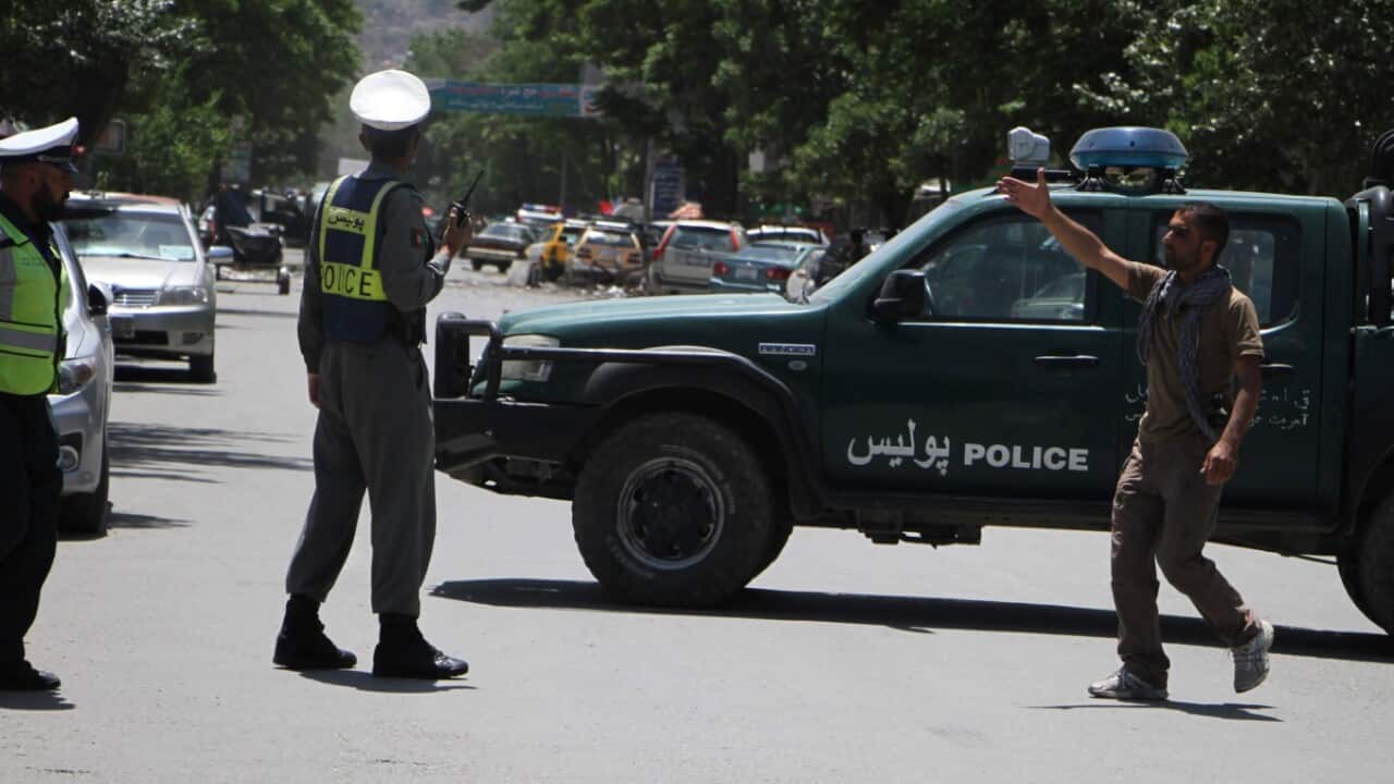 Police officers are seen after a suicide bomber blew himself up near to the Police station