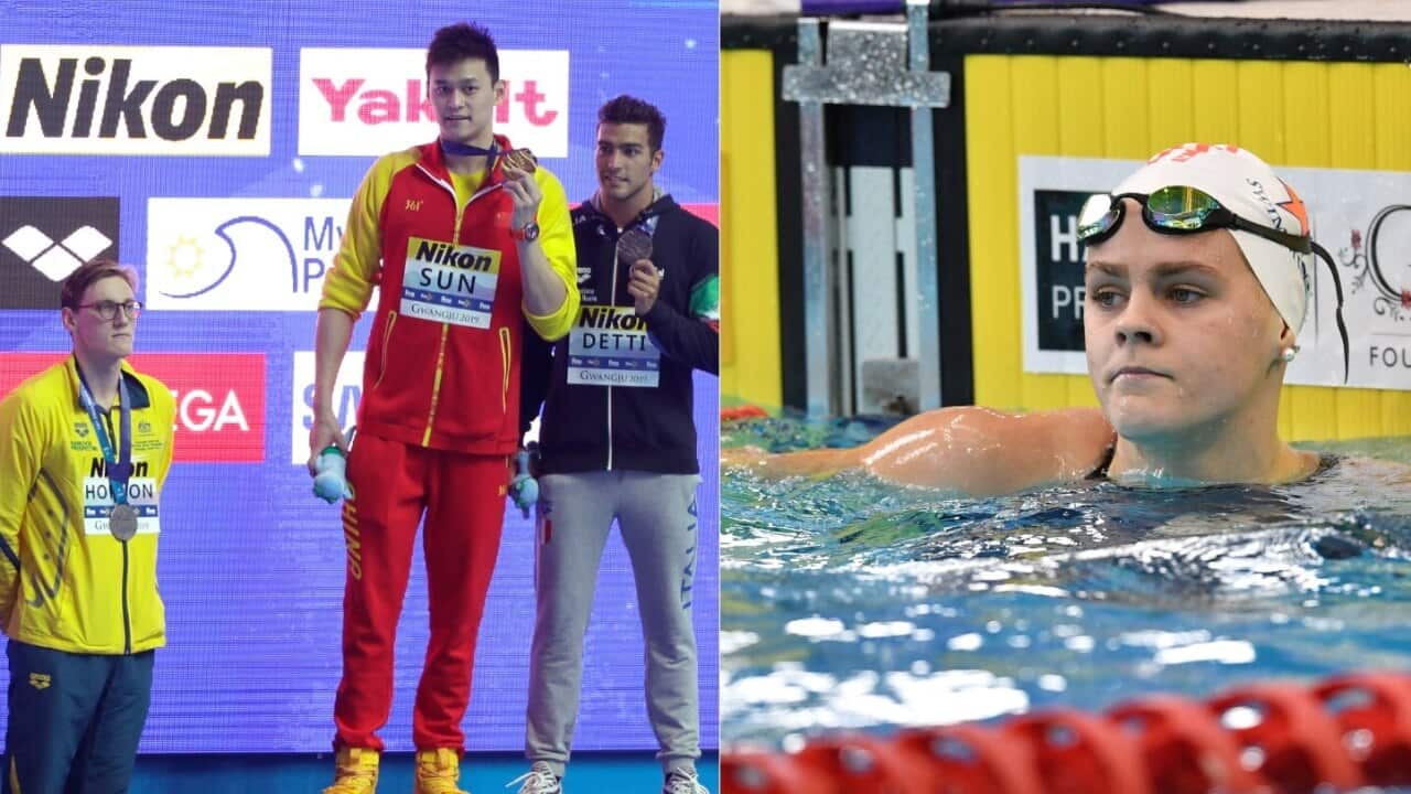 China's Sun Yang holds up his gold medal as silver medalist Australia's Mack Horton, left, stands away from the podium, and Australian swimmer Shayna Jack (R)