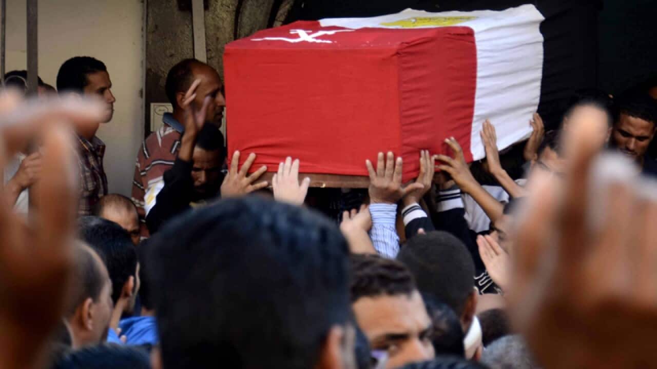 Egyptian mourners attend the funeral for one of the soldiers killed