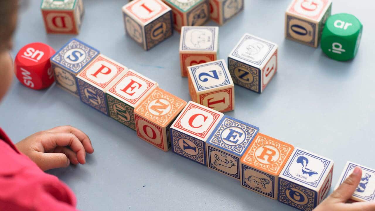 Boy Playing with Alphabet Blocks