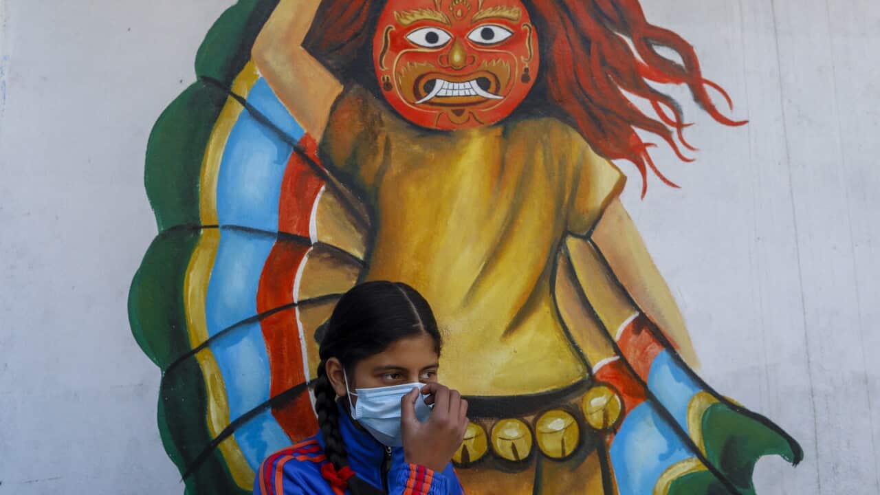 A school girl wears a surgical face masks while standing next to a mural at Janpremi School in Bhaktapur, Nepal, 07 February 2020. EPA/NARENDRA SHRESTHA