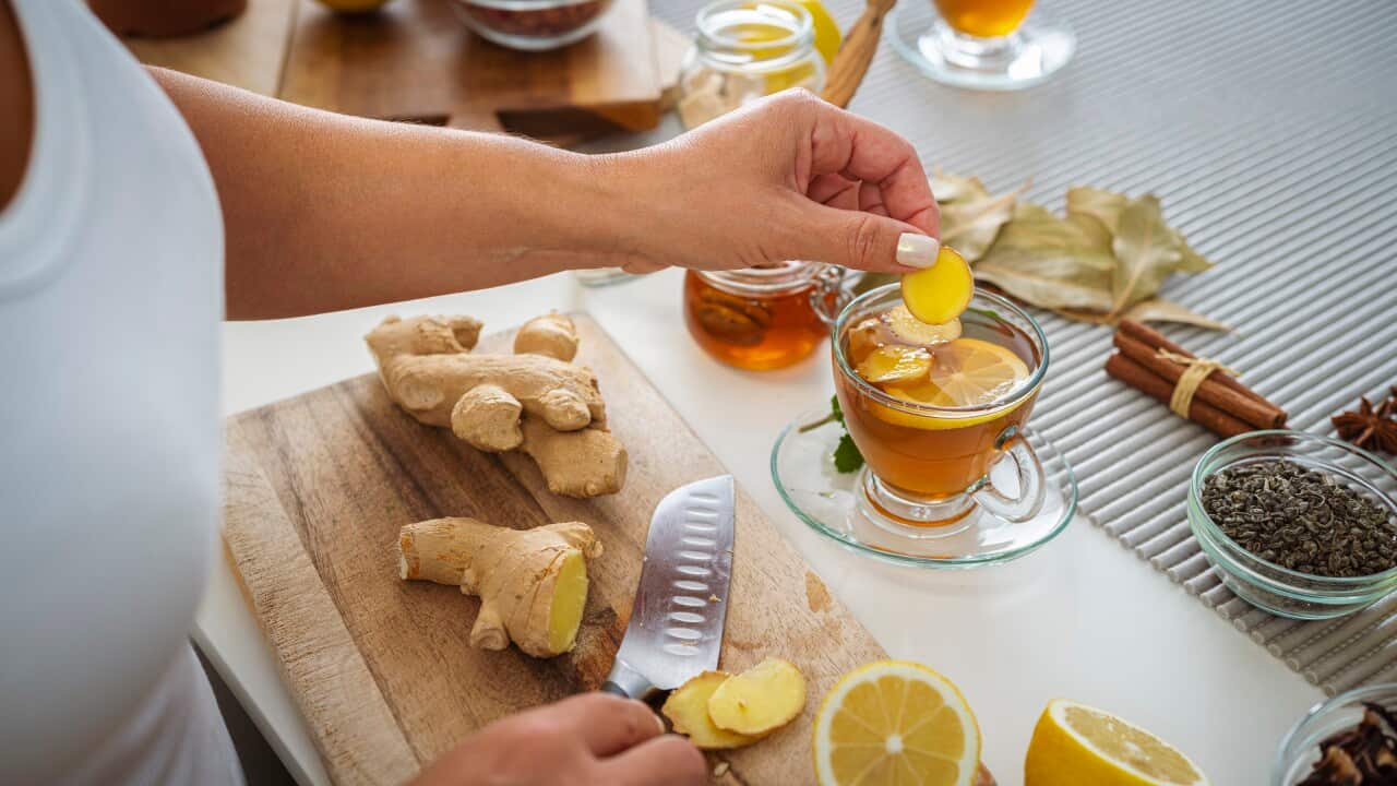 Woman preparing ginger and lemon hot tea