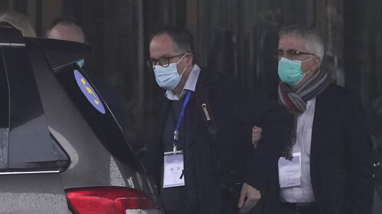 Dominic Dwyer (R) and Peter Ben Embarek of the WHO team prepare to leave for a field visit from their hotel in Wuhan on 1 February, 2021.