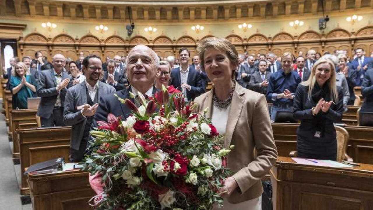 Federal Councillors Ueli Maurer (L) and Simonetta Sommaruga (R) pose with flowers after the election of Maurer as Swiss Federal President and of Sommaruga as Swiss Federal Vice President for 2019.