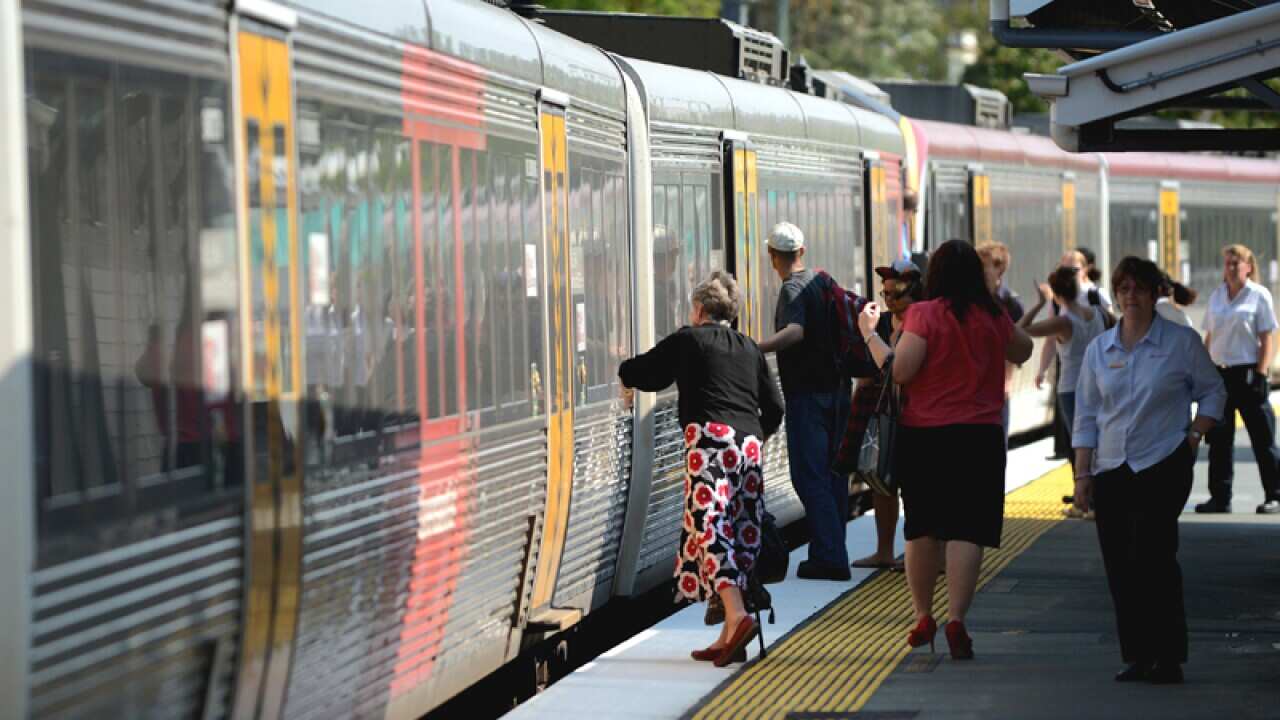 Passengers board a Queensland Rail train