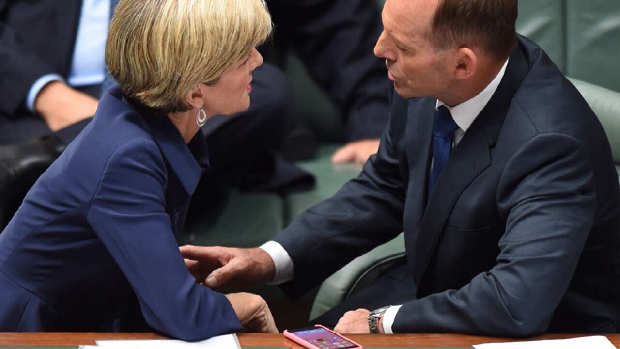 Prime Minister Tony Abbott (R) speaks to Foreign Minister Julie Bishop
