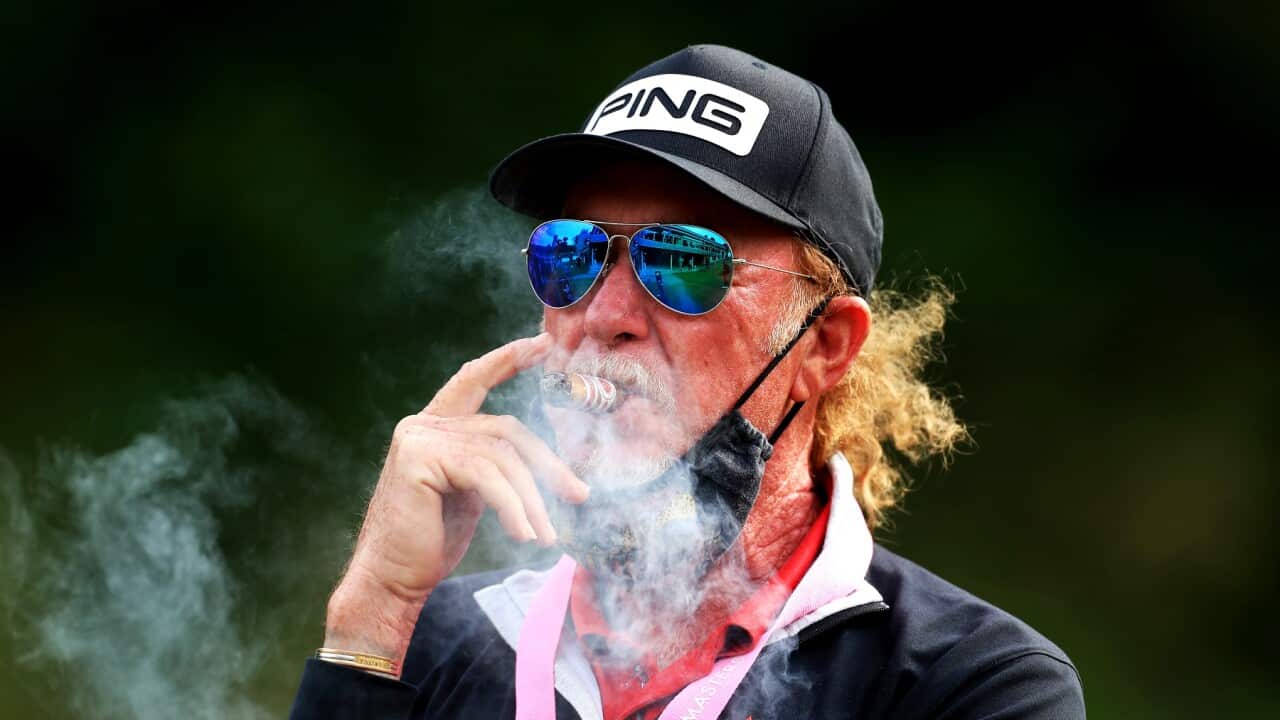 Golfer Miguel Angel Jimenez smokes a cigar