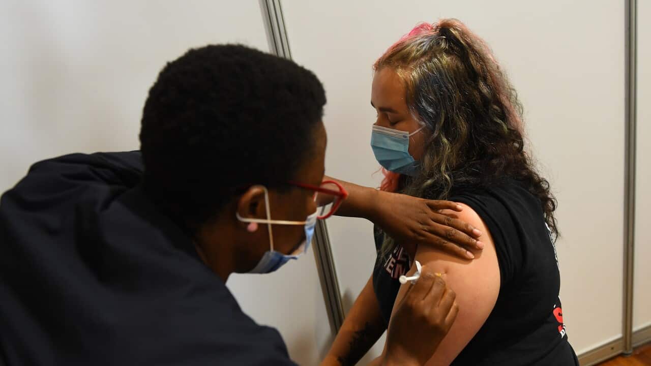 Paramedic Rhiannon Gallatly receives an AstraZeneca COVID-19 vaccination in Melbourne (AAP