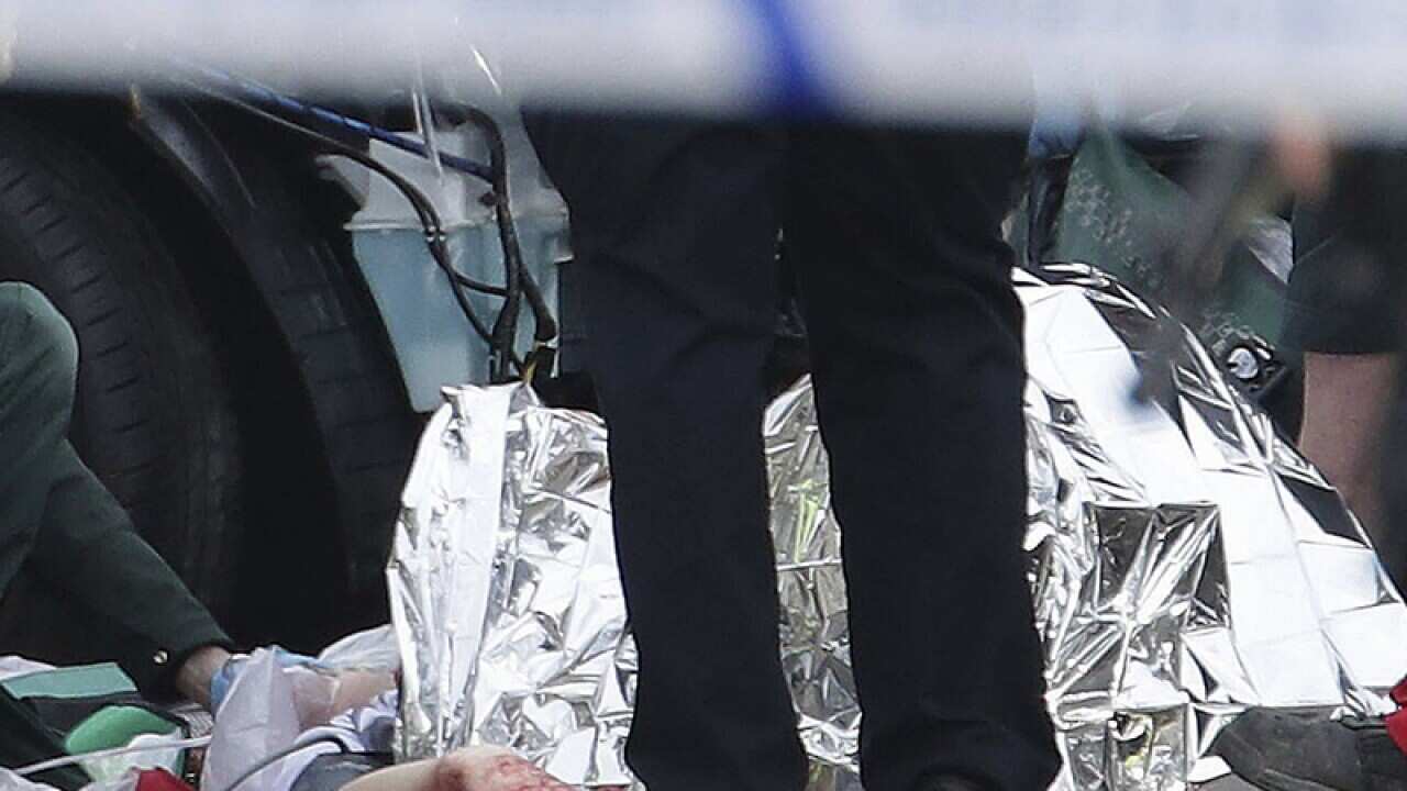 Emergency personnel tend to an injured person