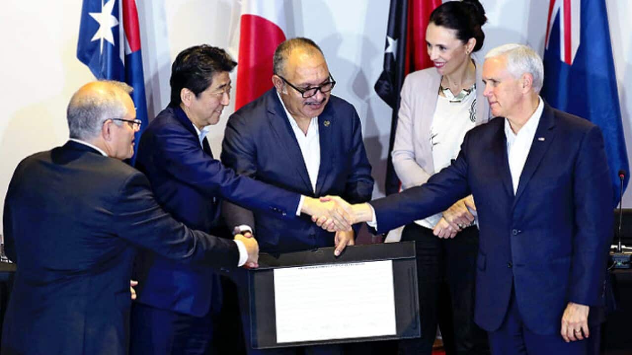 Australia's Prime Minister Scott Morrison shakes hands with other world leaders at a signing ceremony