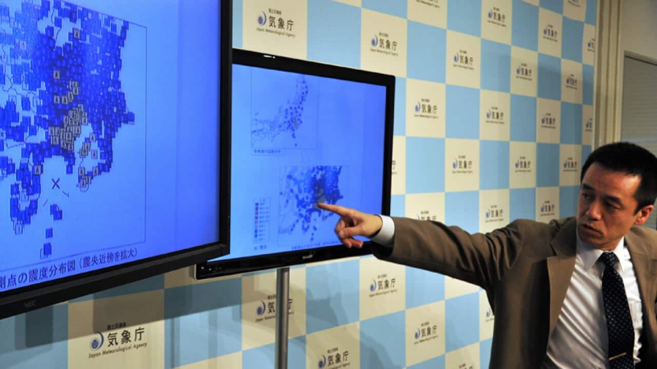 A Japan Meteorological Agency officer speaks during a news conference