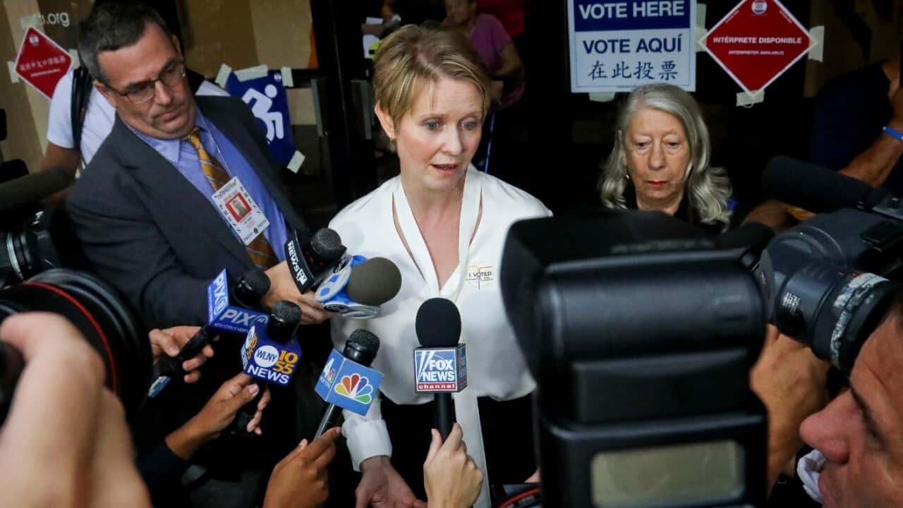 New York gubernatorial candidate Cynthia Nixon, center, speaks to members of the media outside a polling station after voting in the primary