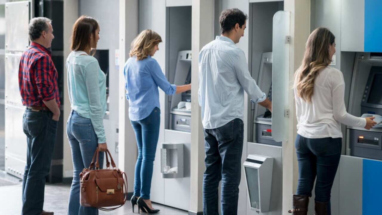 People in a line at an ATM