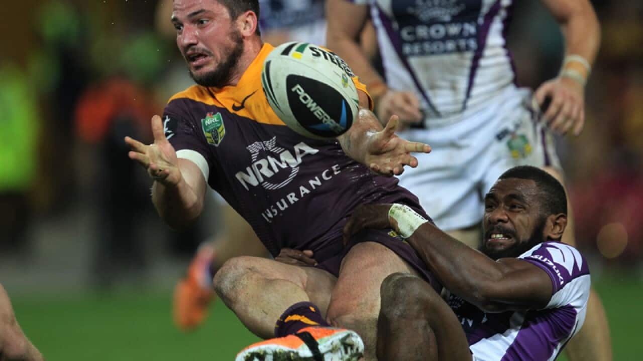 Matt Gillett offloads as he is dragged down by Marika Koroibete