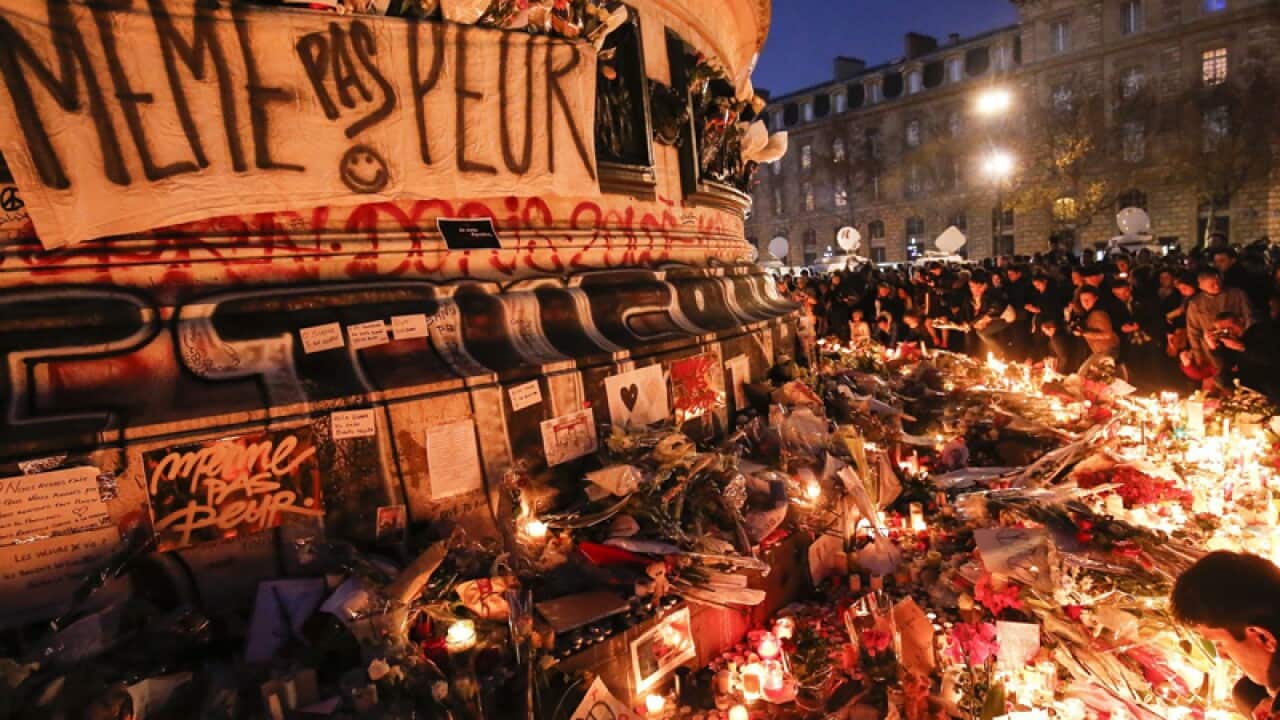 People at a memorial at Place de la Republique in Paris