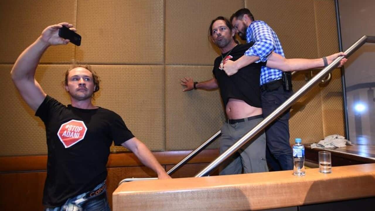 Anti ADANI protesters are removed from the stage