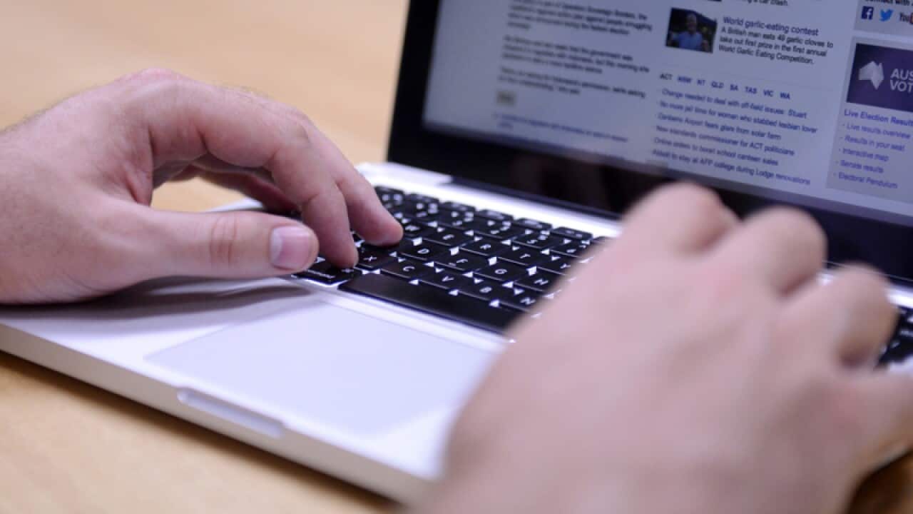 A man uses a laptop computer in Brisbane.