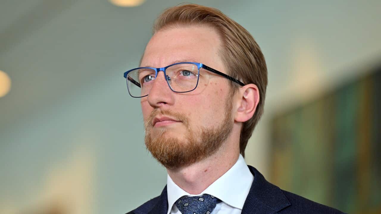 A man with blue glasses.
