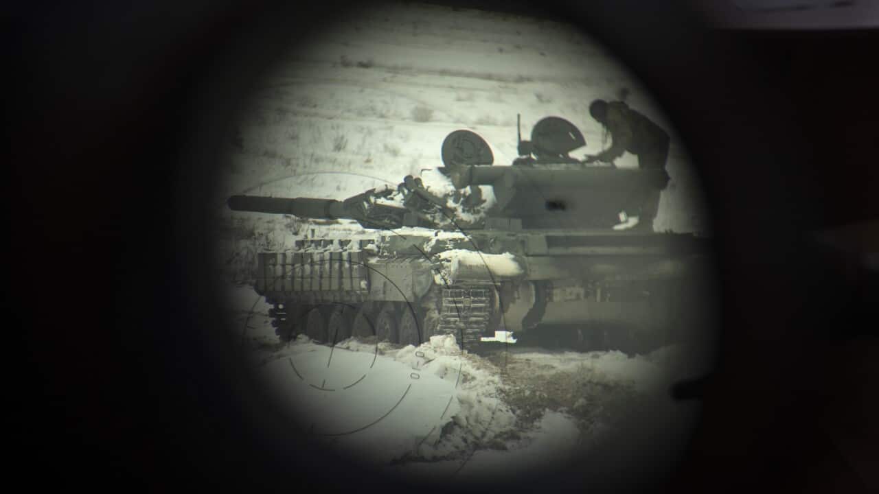 A Ukrainian tank seen through binoculars in Ukraine (AAP)