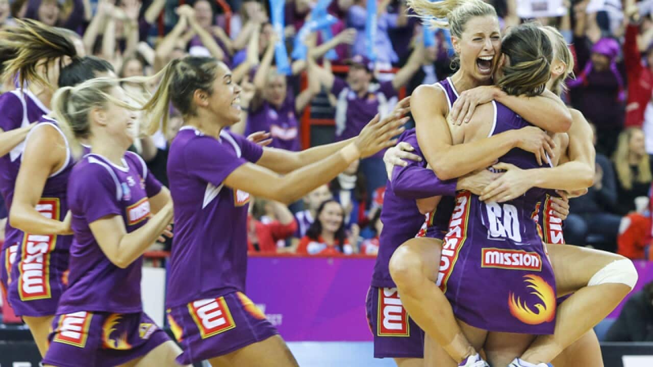 The Firebirds celebrate after winning the Netball Grand final