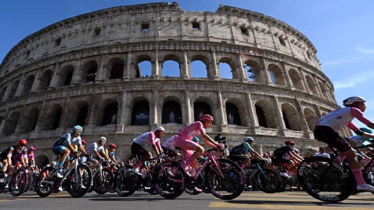 Giro d'Italia cyclists in front of the Coliseum in Rome