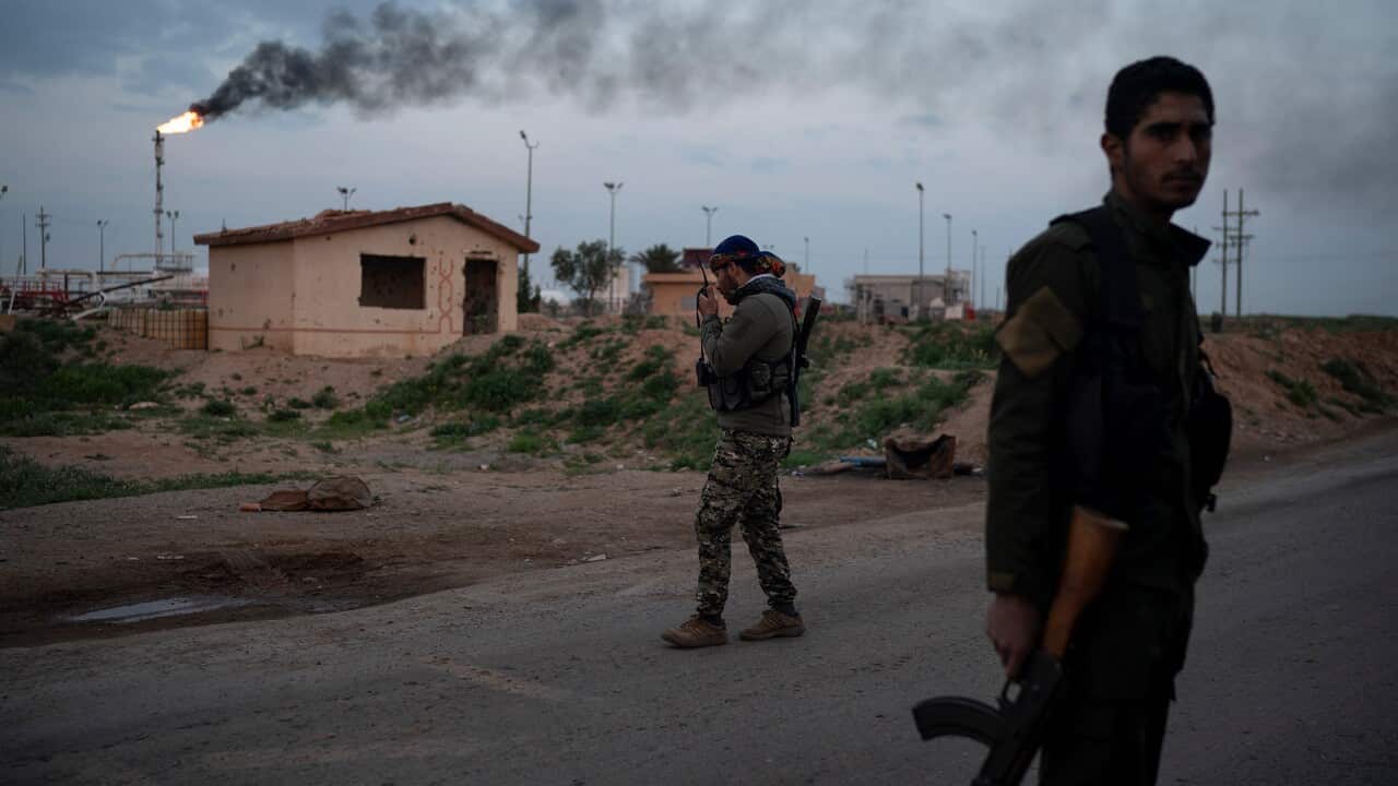 US-backed Syrian Democratic Forces (SDF) fighters in the desert outside Baghouz, Syria.