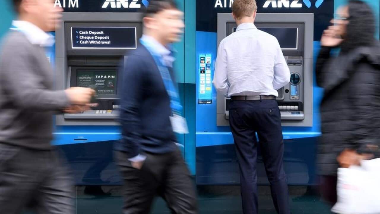 People walking past ANZ Bank ATMs in Sydney