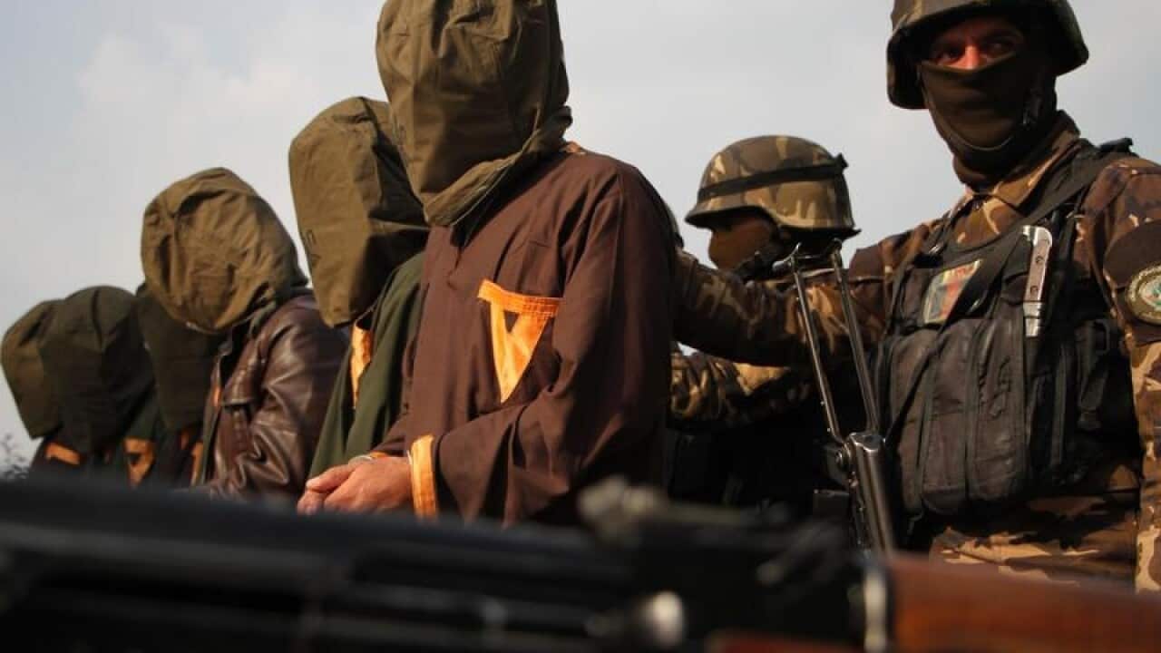 A file image of security forces with a group of militants
