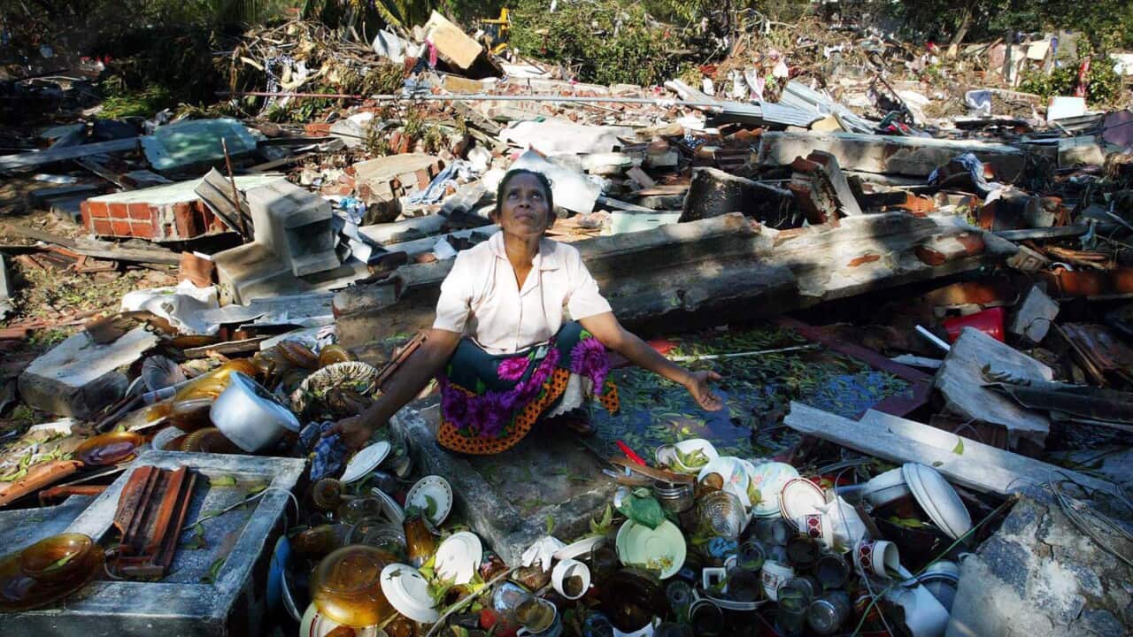 A woman reacts among the debris of her destroyed home in the tsunami-hit town of Hambantota, some 200km south-east of Colombo, Sri Lanka, 30 December 2004