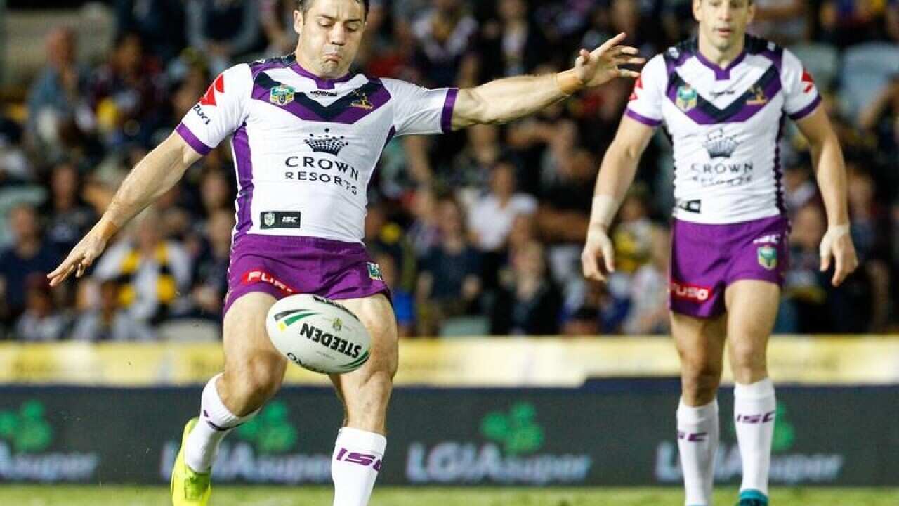Melbourne's Cooper Cronk gets a kick away against the Cowboys