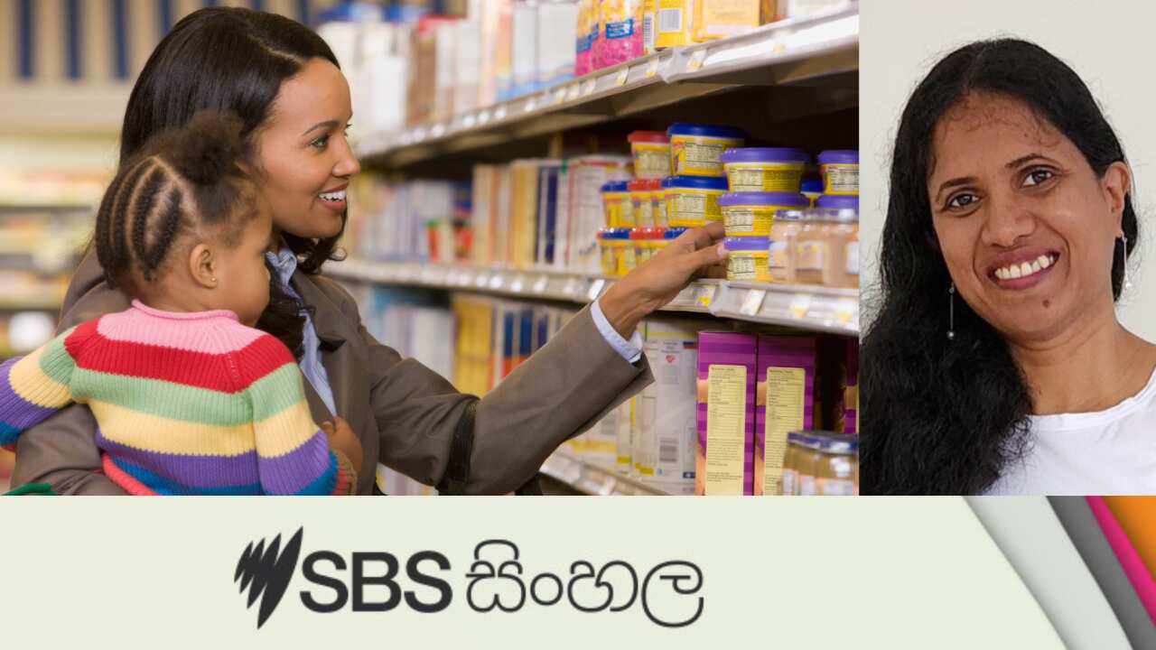 Woman holding daughter at grocery store