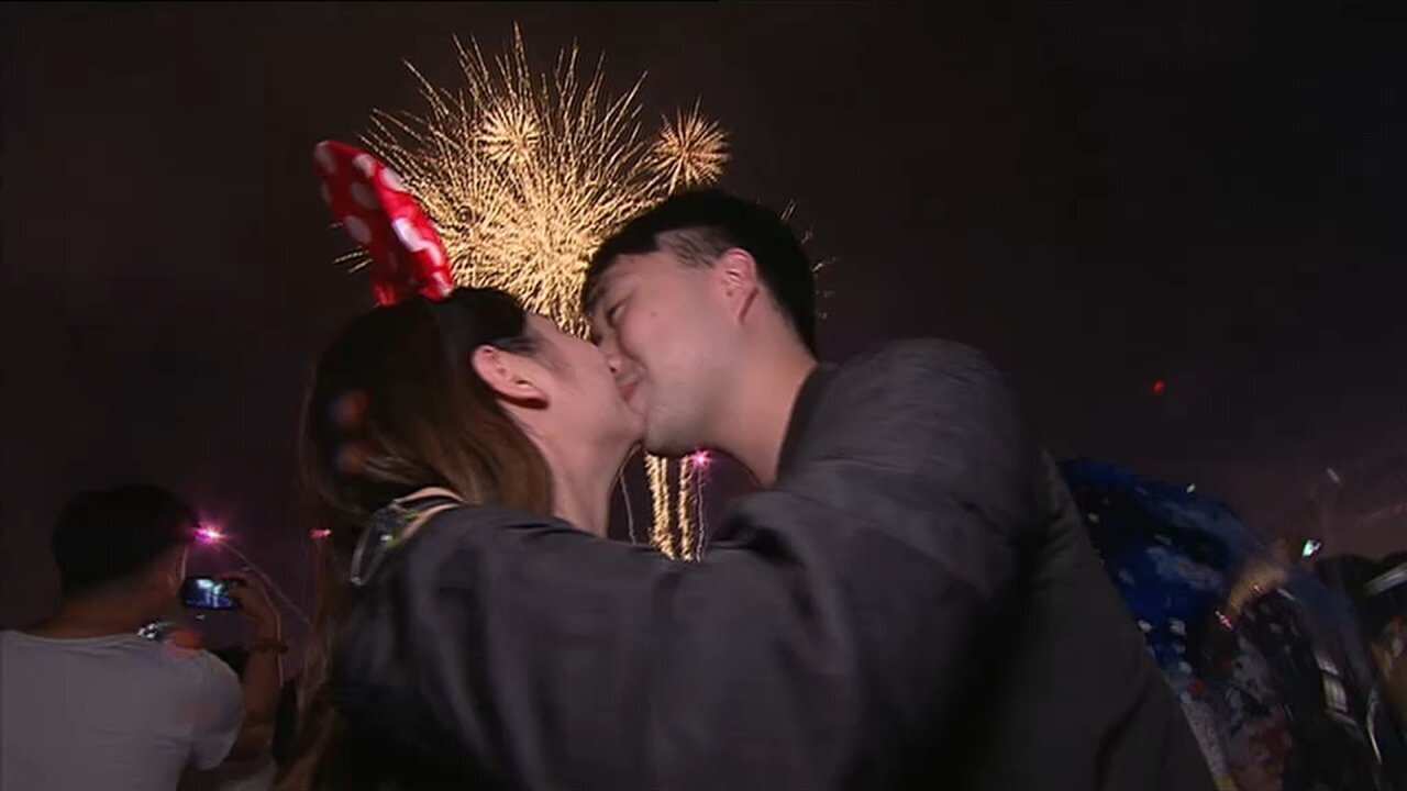 A couple marks the moment when the clock struck midnight.