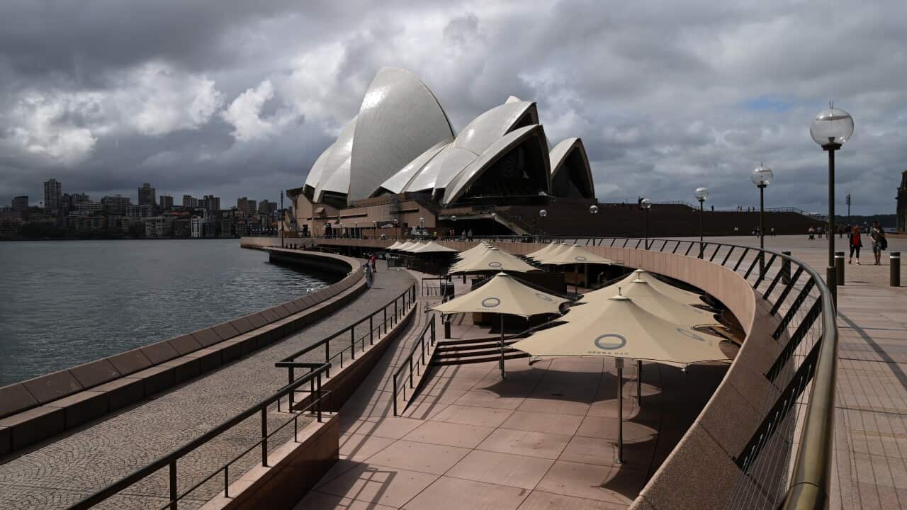 A empty Opera Bar in front of the Sydney Opera House in Sydney, Monday, March 23, 2020. The state of NSW is shutting down all non-essential services to slow the rapidly spreading coronavirus but schools will stay open for now. (AAP Image/Joel Carrett) NO