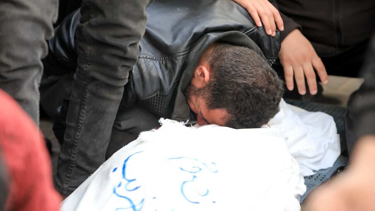 People mourn as they receive the dead bodies of victims of an Israeli strike on March 4, 2024 in Rafah, Gaza.