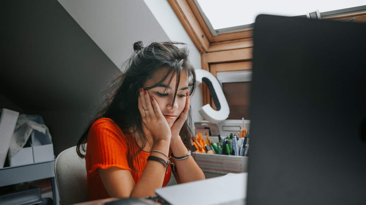 female teenager feeling stressed studing at home.E learning.Home schooling