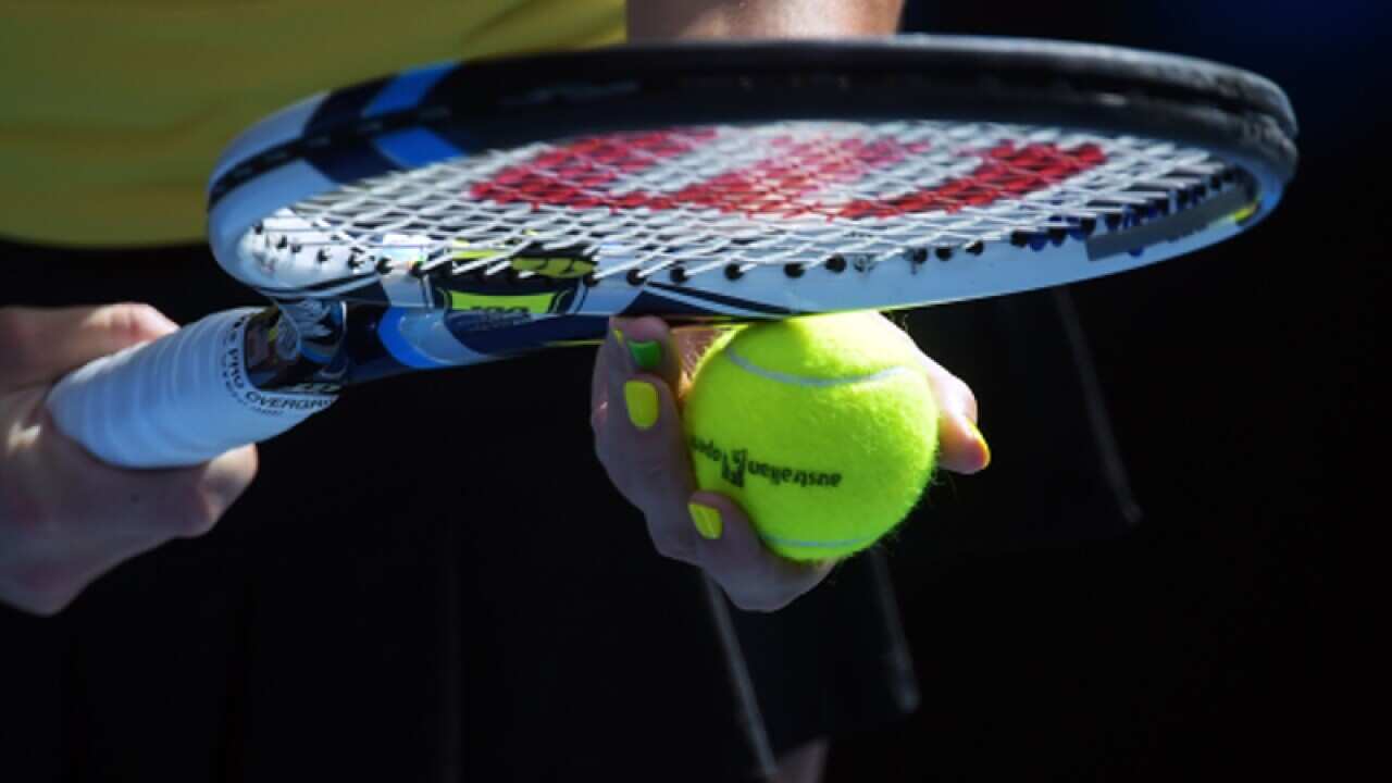An Australian Open tennis ball and a racquet