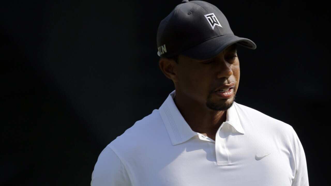 Tiger Woods watches his drive from the driving range