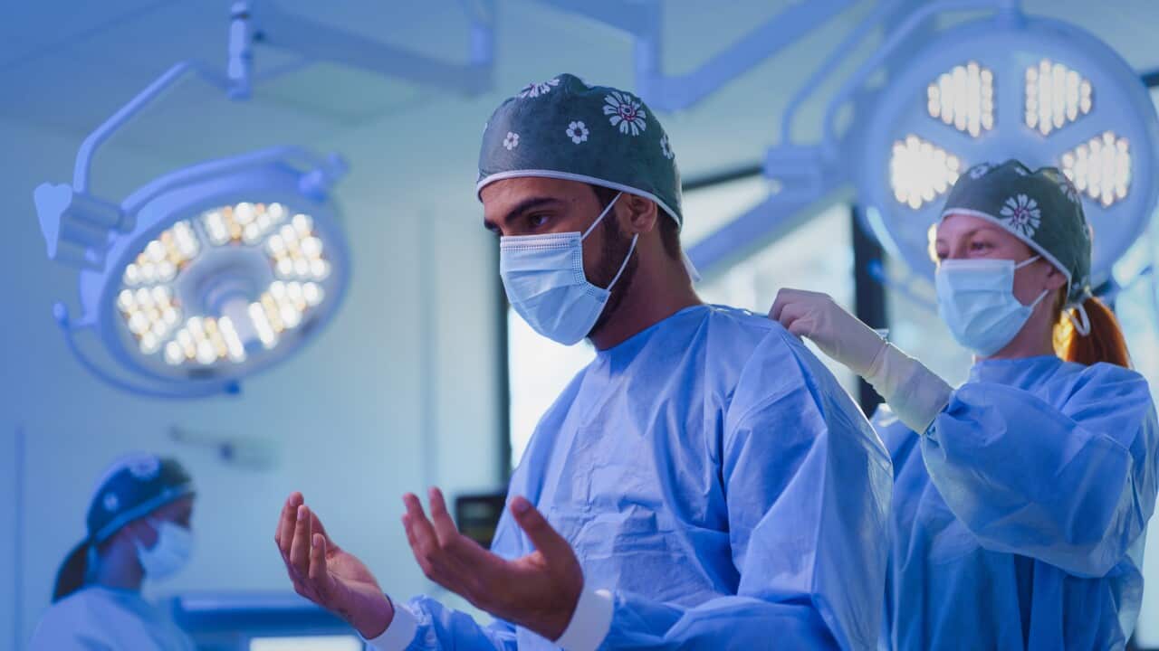 Close-up of surgeon preparing for operation.