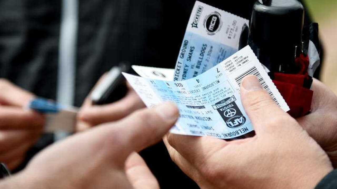 Fans hold their tickets at the Western Bulldogs and Sydney Swans AFL Grand final at th MCG in Melbourne, Saturday, Oct. 1, 2016. (Stock Image)