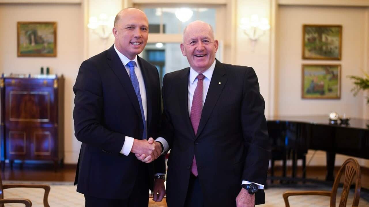 Australian Home Affairs Minister Peter Dutton (left) shakes hands with Australian Governor-General Sir Peter Cosgrove during a swearing-in ceremony at Government House in Canberra, Monday, August 27, 2018. (AAP Image/Lukas Coch) NO ARCHIVING
