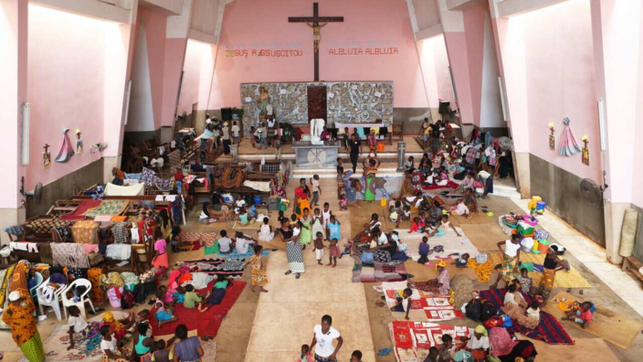 Women and children shelter inside a Roman Catholic Church in Pemba after Cyclone Kenneth