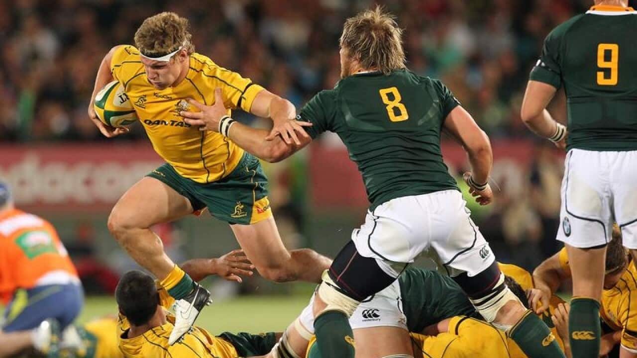 Australia's Michael Hooper challenged by South African players.
