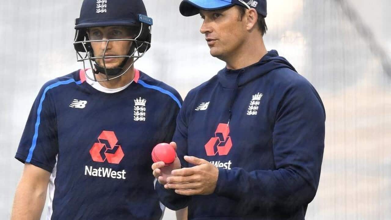 A file image of Shane Bond speaking to Joe Root during training.
