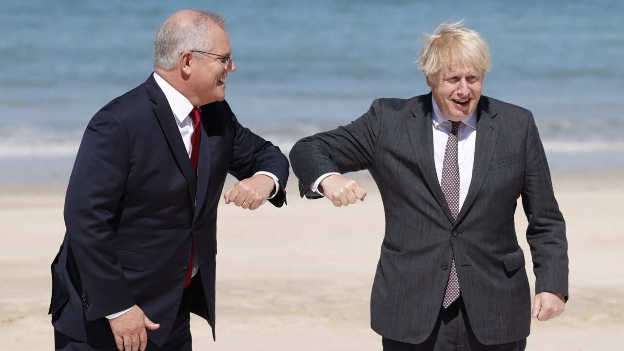 Prime Minister Boris Johnson greets Australian Prime Minister Scott Morrison during the G7 summit in Cornwall.