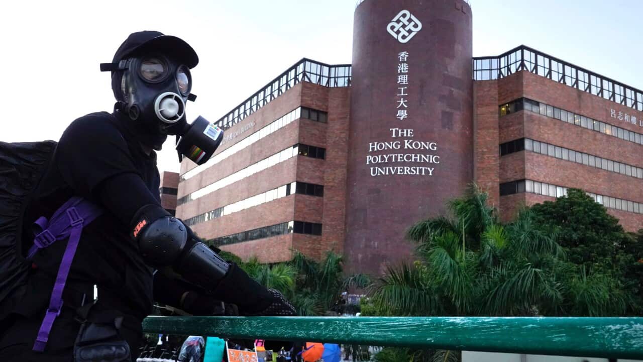 A protestor stands on a bridge near the Hong Kong Polytechnic University in Hong Kong. 