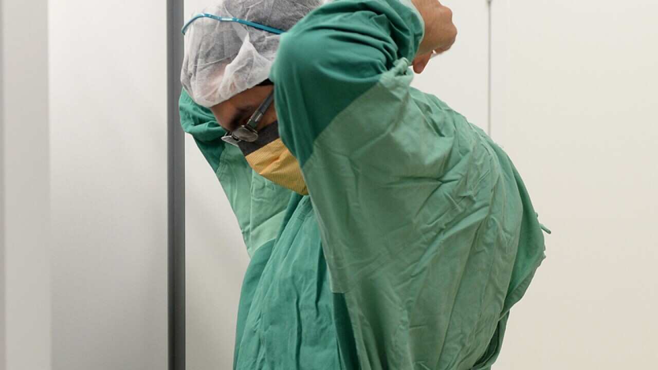 A surgeon prepares for theatre