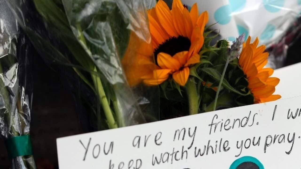 A message card is placed at a collection of flowers left at the Botanical Gardens in Christchurch, New Zealand, Saturday, March 16, 2019.