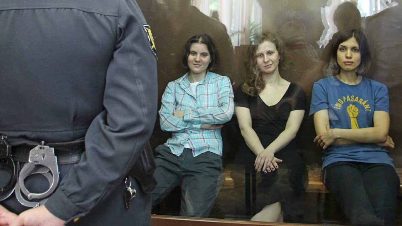 Feminist punk group Pussy Riot members sit in a court room